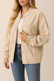 Front view of the khaki corduroy snap-button jacket worn open; rib-knit collar, button placket and slant welt pocket opening visible.