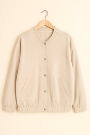 Flatlay front view of the khaki corduroy snap-button jacket with rib-knit stand collar, slant welt pockets, elastic cuffs and hem