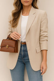 Front view of the khaki longline blazer showing the notched lapel, single-breasted opening and flap pockets.