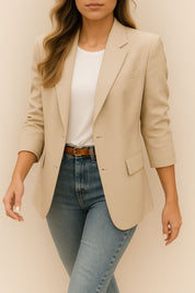 Front view of the khaki longline blazer with notched lapel, single-breasted closure and flap pockets