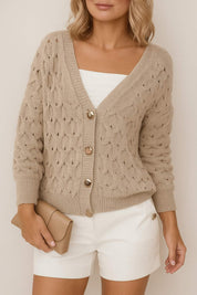 Front view of a women’s khaki textured V-neck cardigan with gold-tone button-front, balloon sleeves, and ribbed cuffs and hem.