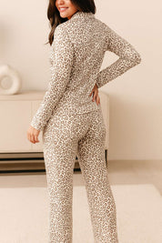 Back view of a woman in leopard print pajama set with long sleeves and full-length pants, soft and cozy loungewear