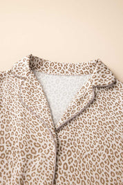Close-up of leopard print pajama top showing notched lapel collar with contrast piping and soft knit fabric texture