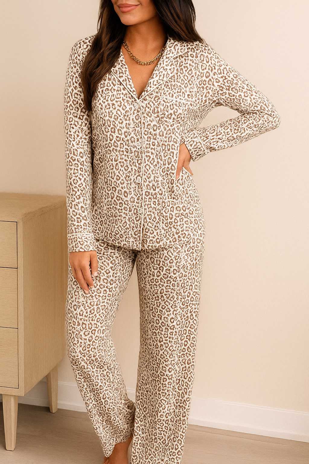 Woman wearing a long sleeve leopard print pajama set with button-down top and matching pants, soft and stylish loungewear