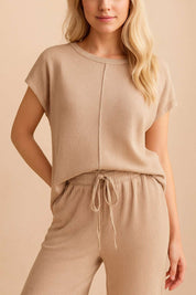Front detail view of a mocha ribbed lounge set highlighting the exposed-seam top and the pants’ elastic drawstring waist