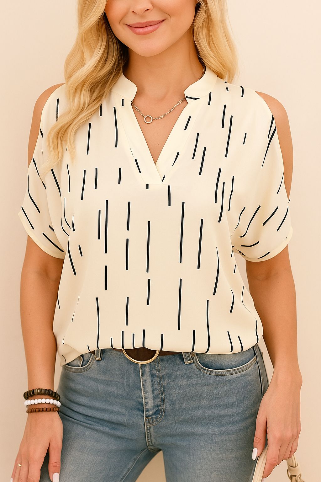 Straight-on front view of the multicolor cold-shoulder notched V-neck blouse styled with jeans; airy woven fabric and clean straight hem.