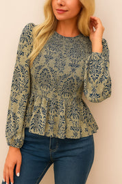 Centered front view of the navy damask jacquard long-sleeve peplum blouse highlighting the smocked waist and textured pattern