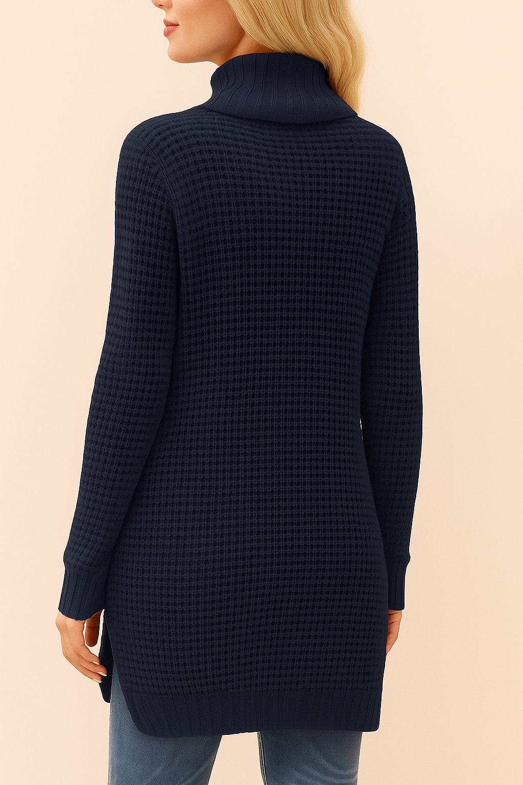 Back view of the navy waffle-knit turtleneck tunic sweater with long sleeves, ribbed hem and cuffs, and overall waffle texture.
