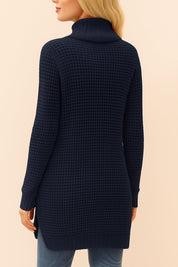 Back view of the navy waffle-knit turtleneck tunic sweater with long sleeves, ribbed hem and cuffs, and overall waffle texture.