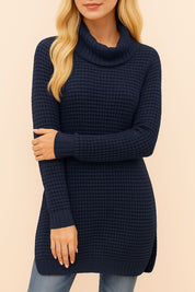 Front detail view of the navy turtleneck waffle-knit sweater showing the soft roll neck, textured waffle pattern and ribbed cuffs