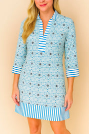 Pastel-blue floral tunic dress with striped collar, cuffs and hem, easy pullover design — mid-length front view