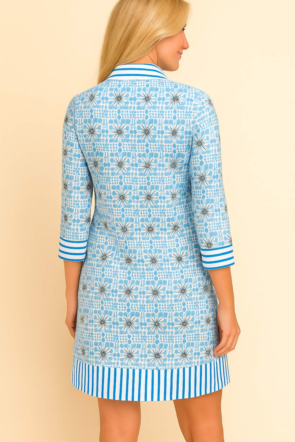 Pastel-blue floral tunic dress with three-quarter sleeves and striped trim at cuffs and hem — back view