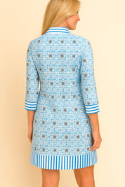 Pastel-blue floral tunic dress with three-quarter sleeves and striped trim at cuffs and hem — back view