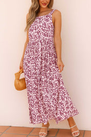 Pink-floral square-neck sleeveless maxi dress with relaxed drape, styled with round woven bag — front view