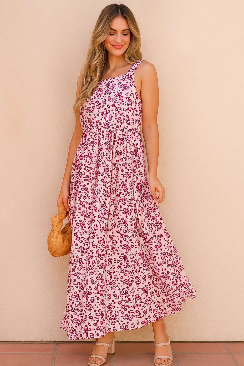 Pink-floral square-neck sleeveless maxi dress styled for summer with airy A-line sway — outdoor front three-quarter view.