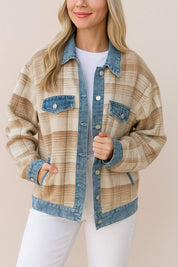 Front three-quarter view of a women’s plaid shacket with denim collar, placket, cuffs and hem, chest flap pockets and side pockets.