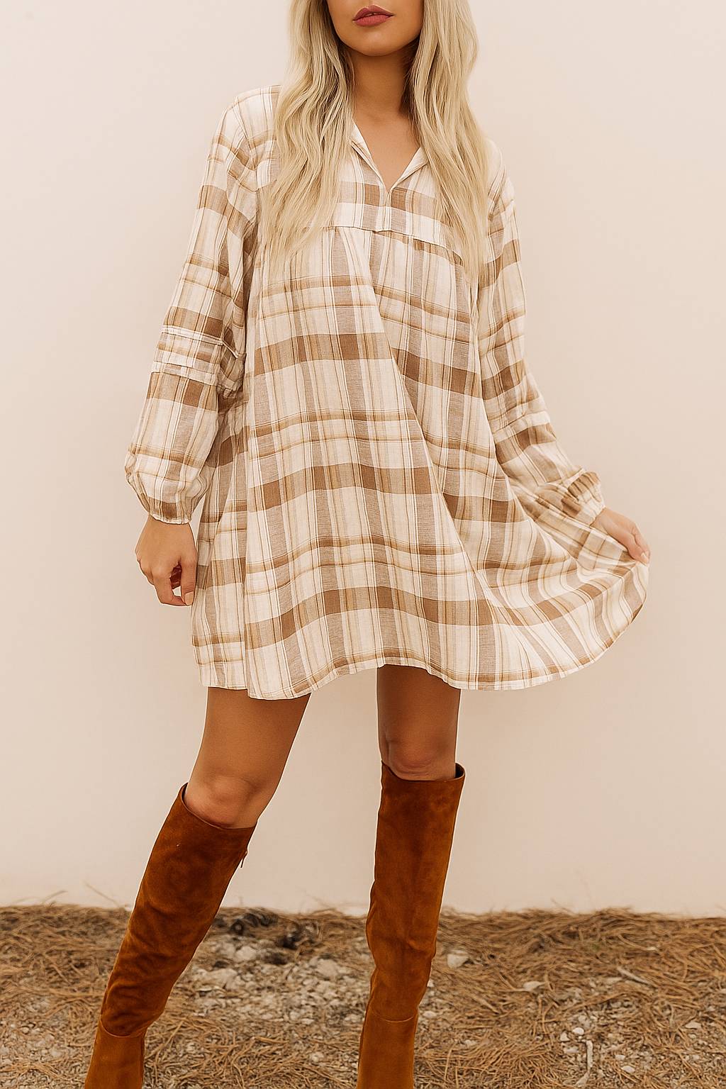 Woman wearing a loose plaid mini dress with long sleeves and v-neckline – styled for a cozy seasonal look
