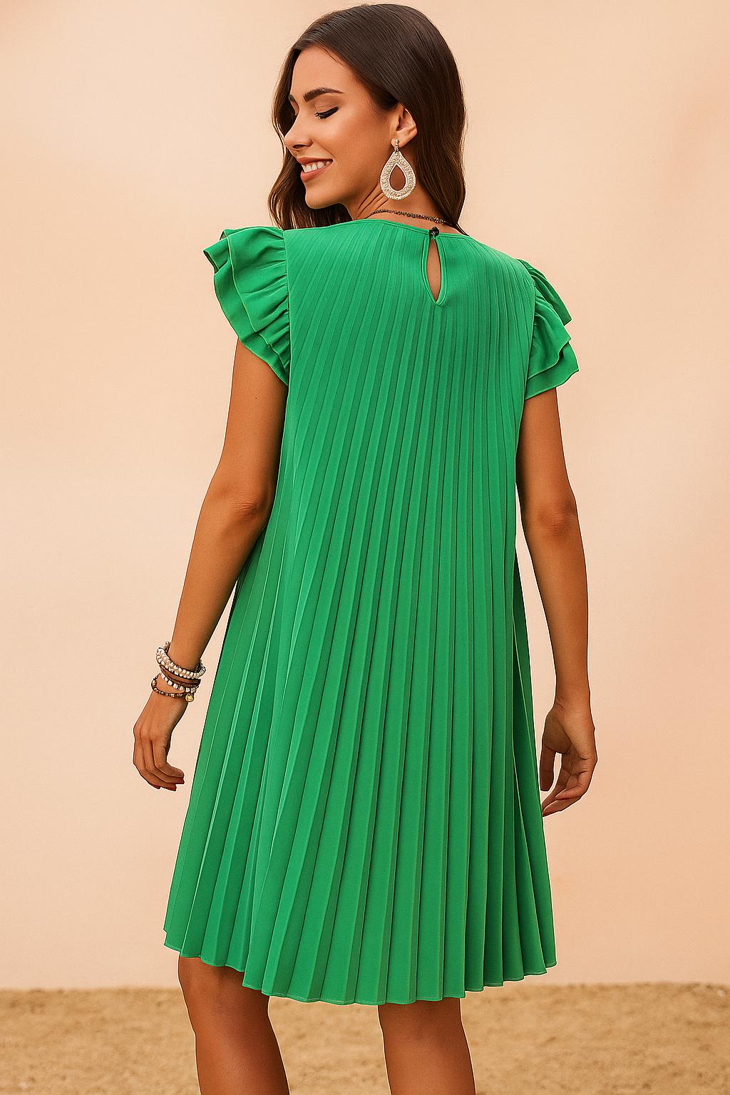 Back view of a woman turning in a green pleated mini dress with ruffle sleeves and teardrop earrings, showing flowy swing movement and summer charm.