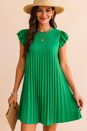 Front view of a woman wearing a pleated green mini dress with ruffle sleeves, straw hat, gold layered necklaces and a woven clutch — perfect sunny day outfit.