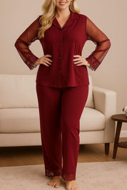 Plus size woman wearing a burgundy pajama set with sheer dotted sleeves and lace trim, elegant and comfortable sleepwear