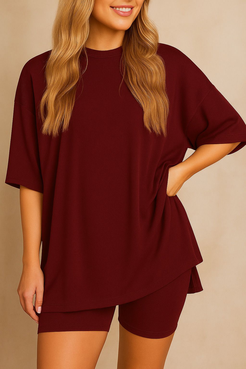 Plus size woman wearing an oversized burgundy lounge set with round neck top and matching shorts