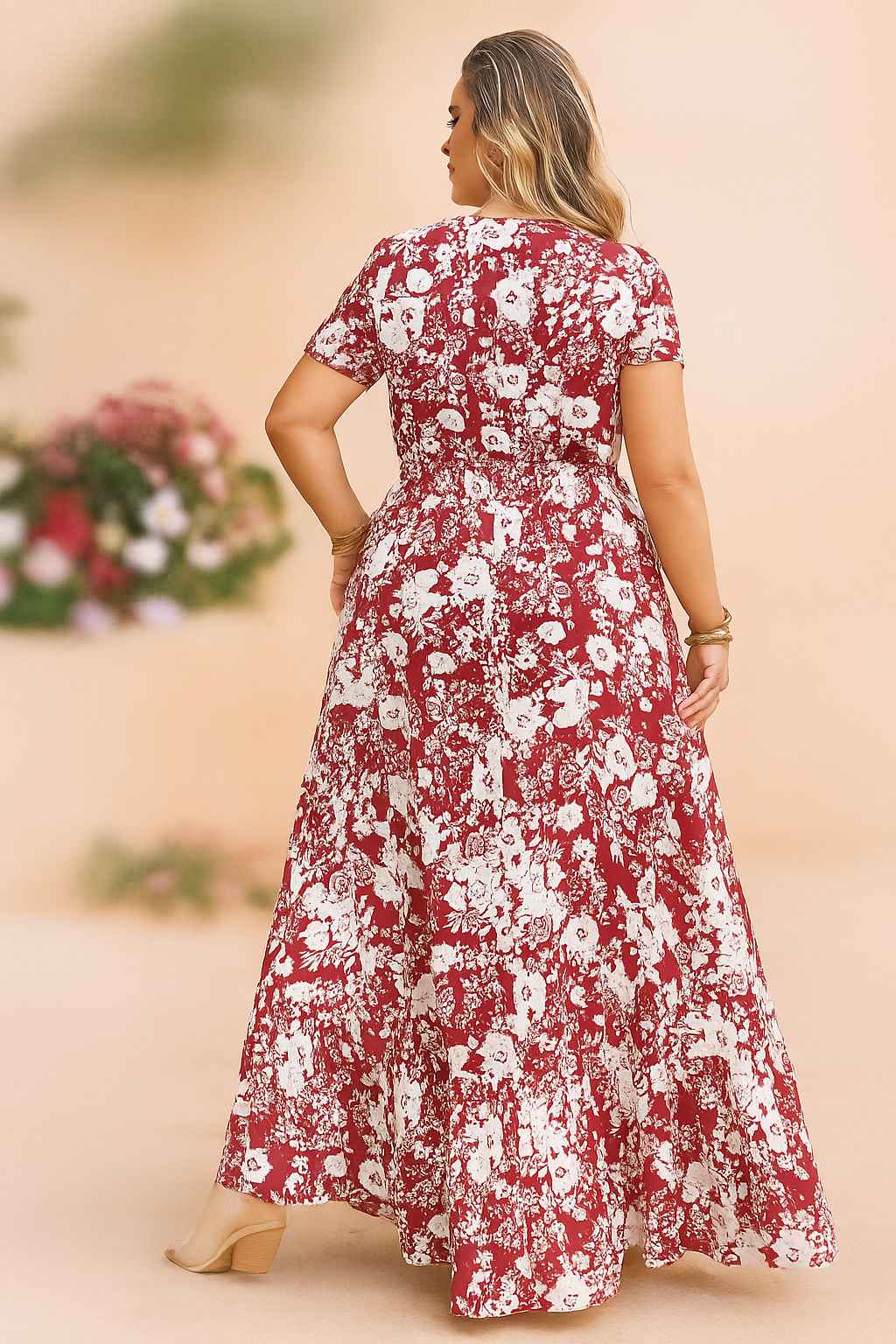 Back view of a woman in a red and white floral plus-size maxi dress with short sleeves, showcasing flowy fabric and flattering silhouette.