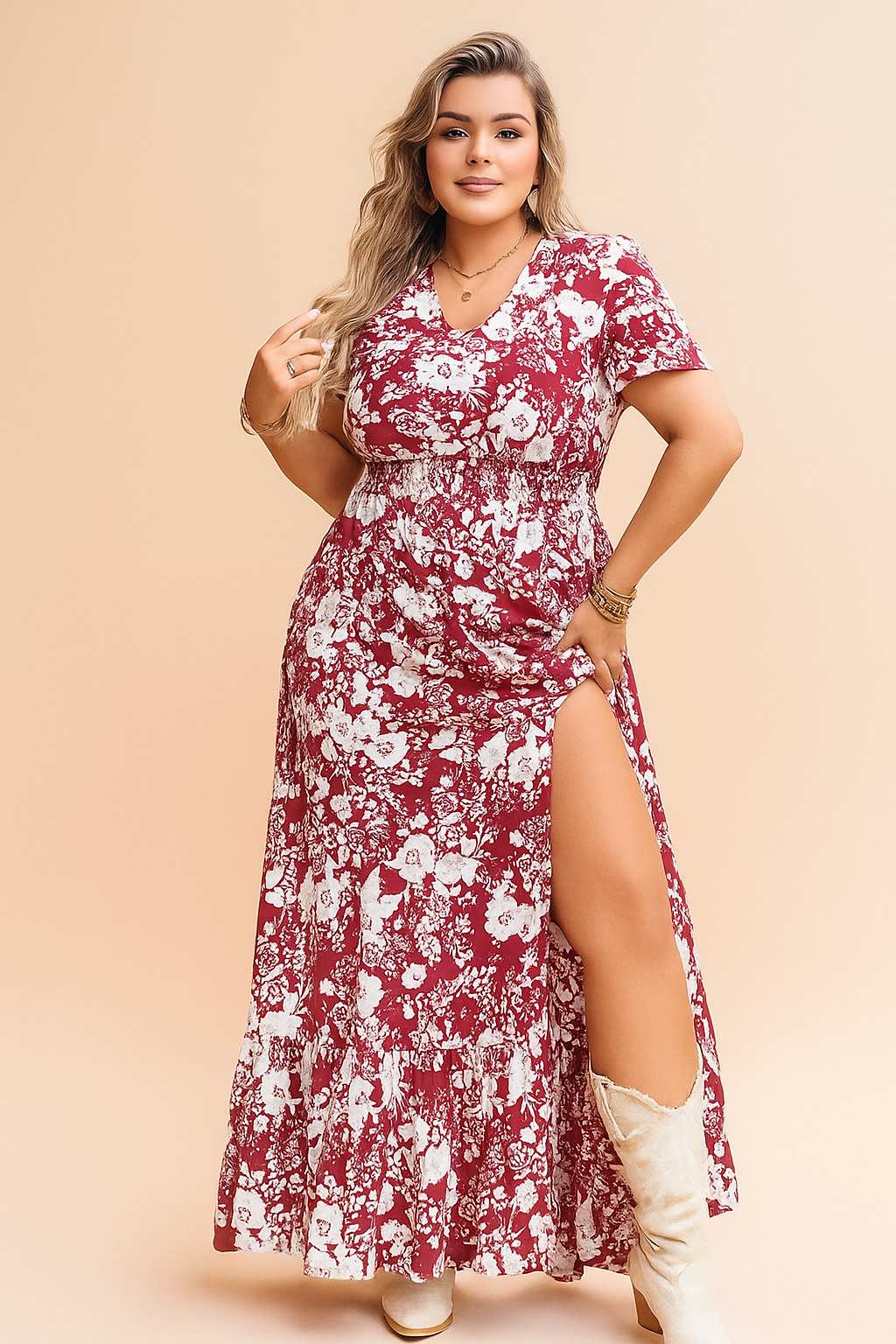 Confident woman in a red floral V-neck maxi dress with side slit, styled with white boots — perfect boho-chic summer outfit.