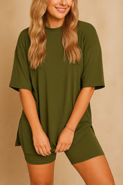 Plus size woman in olive green oversized lounge set with hands forward, showing relaxed fit top and shorts