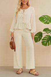 Short studio lookbook video of a cream tie-front peplum blouse with matching wide-leg pants and elastic waist.