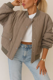 Short lookbook video showing the quilted bomber jacket in taupe, ivory and black with rib-knit trims, zip front and snap-flap pockets from front, side and back views