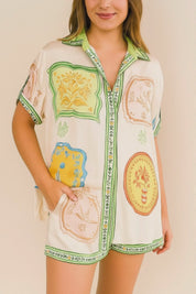 Short lookbook video showing an ivory-multi printed shirt-and-shorts set with button-up shirt, shirt collar and relaxed drape, presented in studio lighting.