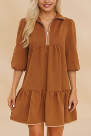 Short video showcasing a women’s chevron-textured mini dress with a collared half-zip neckline, puff three-quarter sleeves, and a relaxed swing ruffle hem.