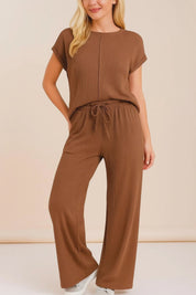 Short studio lookbook video of a brown ribbed lounge set with an exposed-seam short-sleeve top and wide-leg drawstring pants