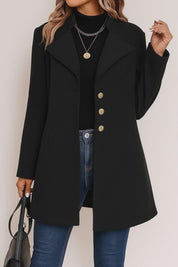 Short lookbook video showing the black tailored button-up coat with notched lapel, gold-tone buttons and straight hem from front and back views.