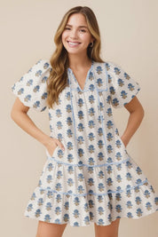 Dusty-blue floral-embroidered cotton babydoll mini dress with puff sleeves, tiered skirt and side pockets — studio lookbook video.