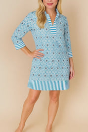 Pastel-blue floral tunic dress with split V-neck and striped trim at collar, cuffs and hem, three-quarter sleeves — studio lookbook video.