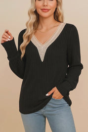 Short lookbook video showing a black ribbed V-neck blouse with beige crochet trim and long sleeves from front and detail views.