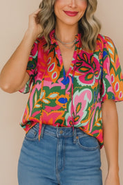 Short studio lookbook video of a rose-multi tropical print tie-neck short-sleeve blouse showing the neckline ties and relaxed drape