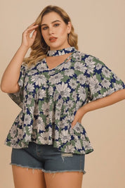 Short studio lookbook video of a dark blue floral blouse featuring a cutout choker V-neckline and flutter sleeves, shown on-body.