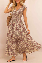 Purple boho-print V-neck cap-sleeve maxi dress with smocked bodice and tiered skirt — front three-quarter view