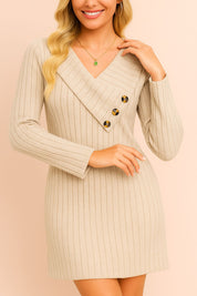 Straight-on front view of the long-sleeve ribbed sweater dress highlighting the asymmetric foldover V-neck collar with three buttons, vertical ribbing and a neat mini-length hem.