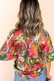Back view of the rose-multi tropical print short-sleeve blouse showing the overall pattern and straight back hem