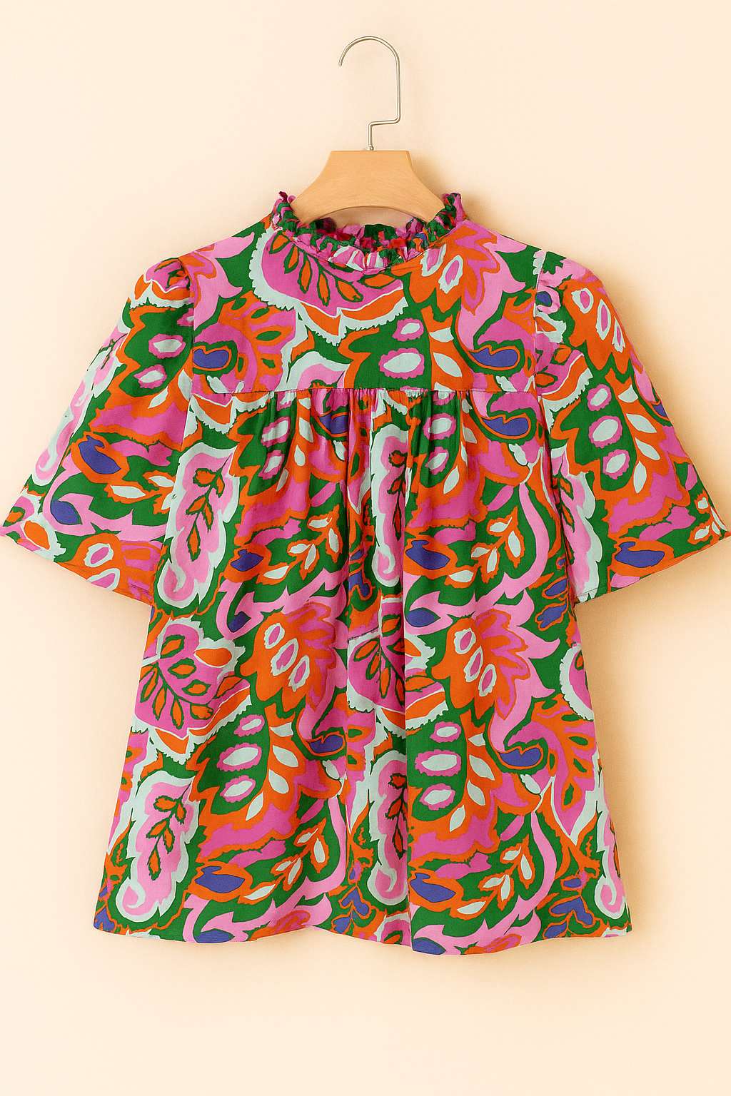 Hanger flatlay, back view of the rose-multi tropical print blouse showing the gathered yoke and full back panel