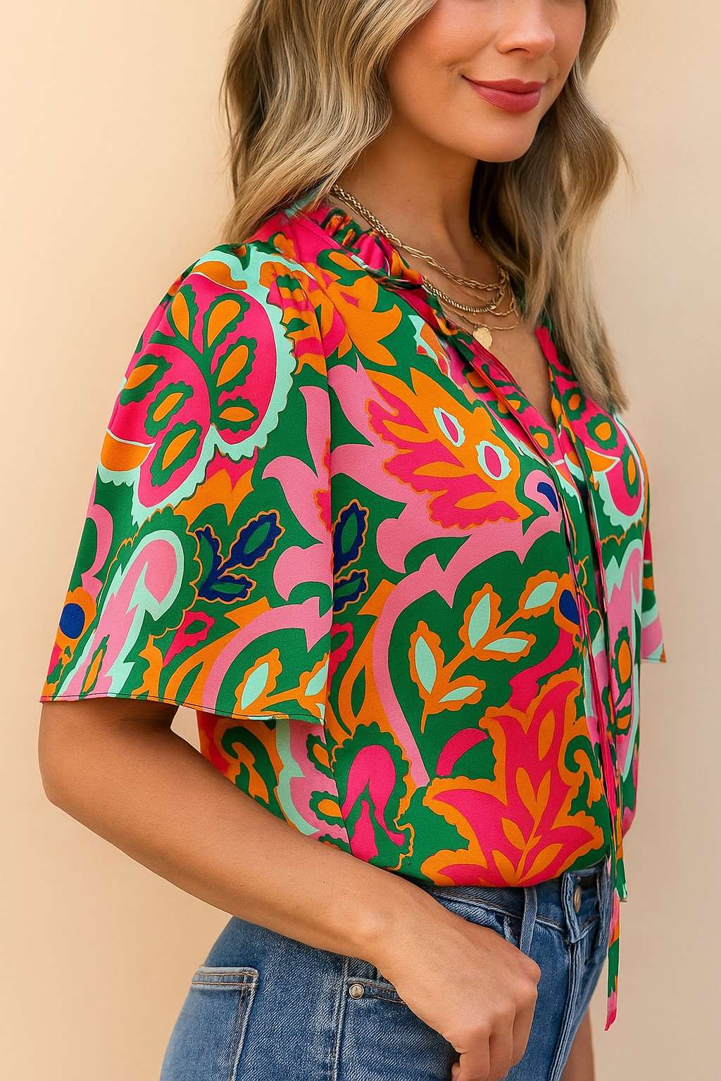 Left side view of the rose-multi tropical print tie-neck short-sleeve blouse highlighting the sleeve shape and side profile.