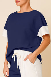 Front detail view of the royal-blue and white colorblock top and the pants’ drawstring elastic waist.
