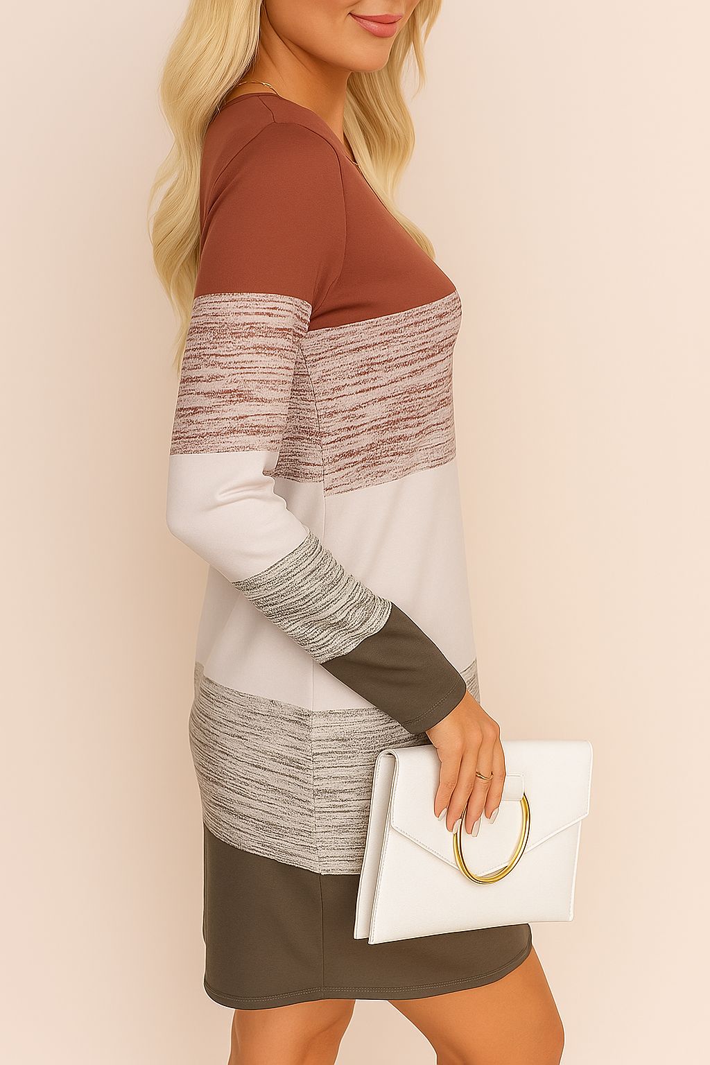 Side profile of a blonde woman in a long sleeve mini dress with earth-tone colorblocks and a white clutch – casual chic outfit