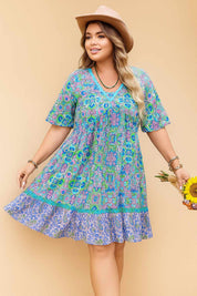 Plus-size sky-blue boho-print dress with lace V-neck and flowy skirt — front three-quarter view.
