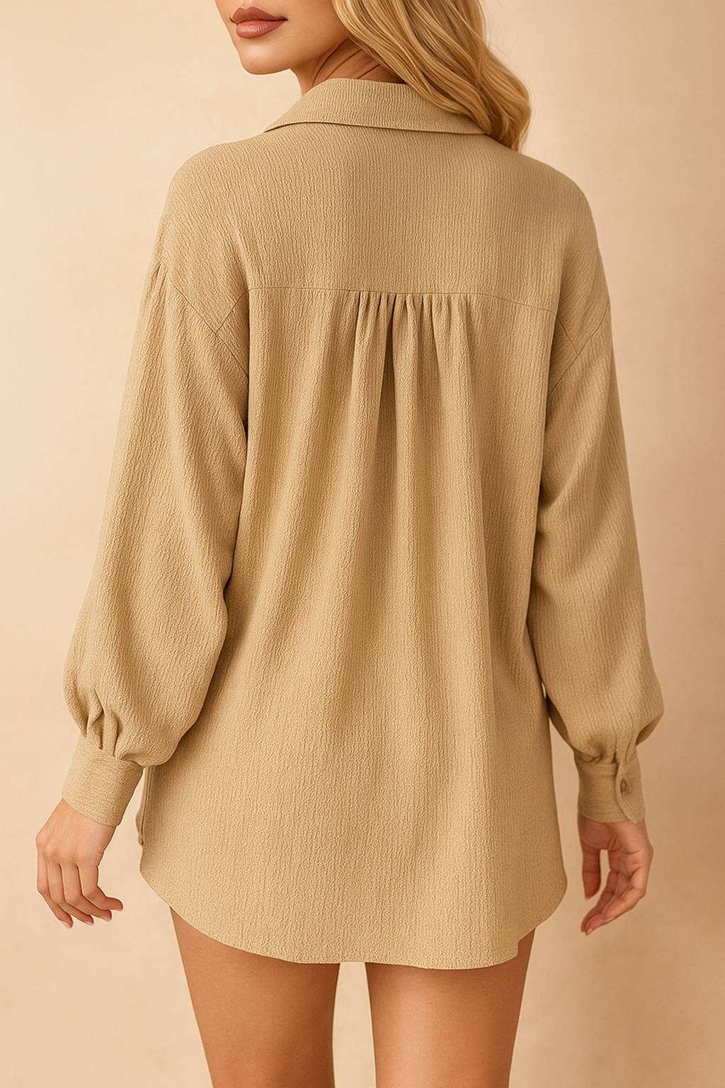 Back view of the tan crinkle set highlighting the shirt’s gathered back yoke and curved hem with cuffed long sleeves.