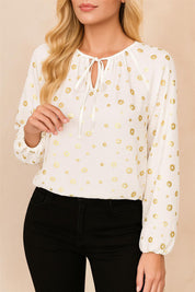 White tie-neck blouse with gold-foil dot print, gathered neckline and elastic-cuff sleeves — front three-quarter view