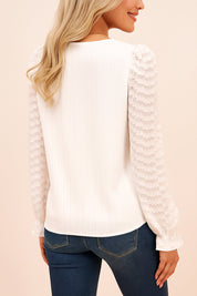 White lace-trim V-neck blouse with ribbed back panel, sheer textured sleeves and a curved hem — back view.